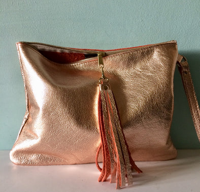 Rose gold leather Clarke clutch with wristlet handle