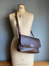 dark brown leather handbag with crossbody strap