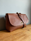 Tan brown leather handbag with crossbody strap