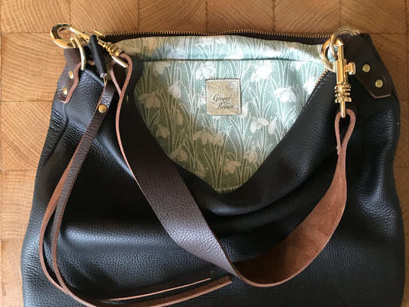 Dark brown leather purse with a shoulder strap