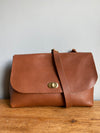 Tan brown leather handbag with crossbody strap