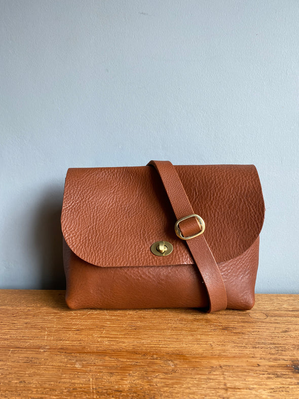 Tan brown leather handbag with crossbody strap