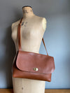 Tan brown leather handbag with crossbody strap