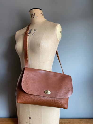 Tan brown leather handbag with crossbody strap