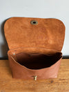 Tan brown leather handbag shown open with interior on view