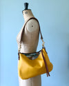 Yellow leather purse with shoulder strap  