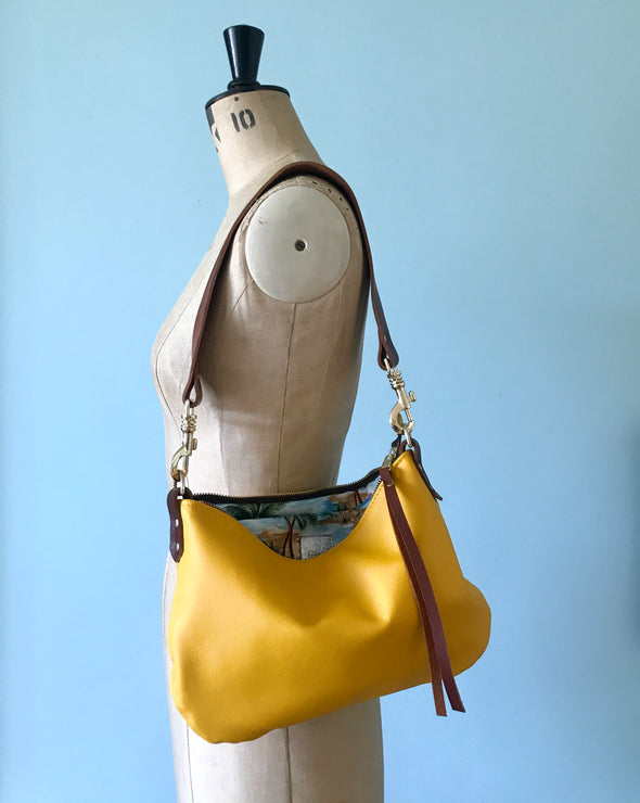 Yellow leather purse with shoulder strap  