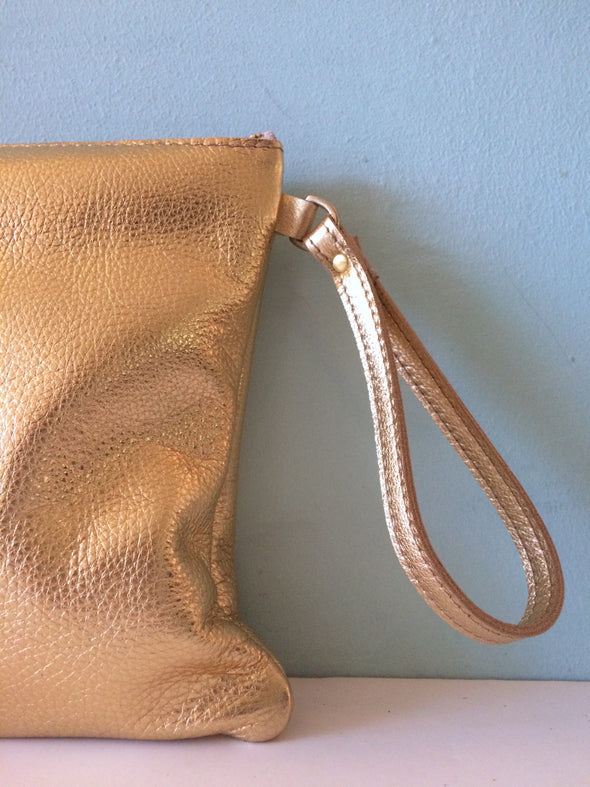 Bright gold leather Clarke clutch with wristlet handle