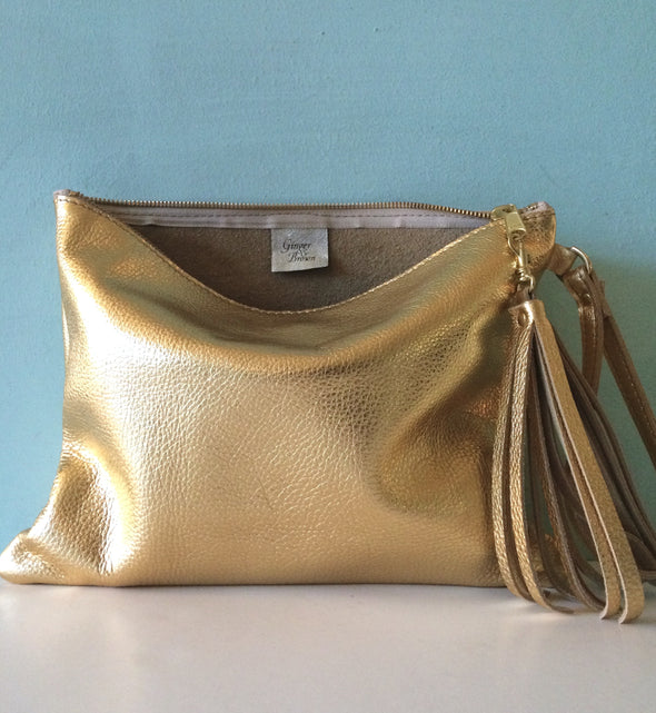 Bright gold leather Clarke clutch with wristlet handle