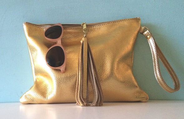 Bright gold leather Clarke clutch with wristlet handle