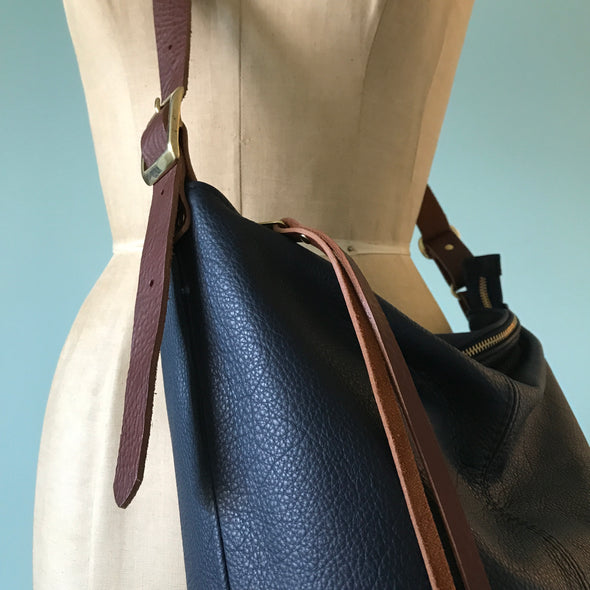 Navy blue leather Clarissa bucket bag with crossbody strap