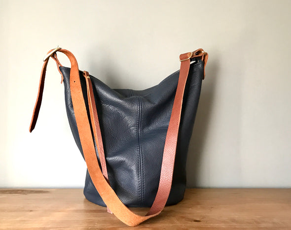 Navy blue leather Clarissa bucket bag with crossbody strap