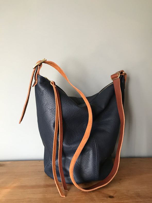 Navy blue leather Clarissa bucket bag with crossbody strap