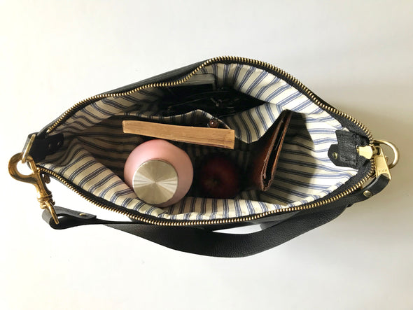 Dumpling messenger bag in black - crossbody / shoulder bag