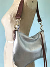 silver leather purse with shoulder strap  