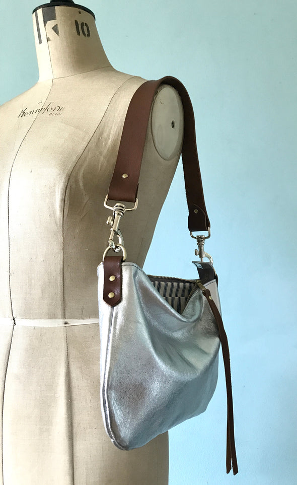 silver leather handbag with shoulder strap  Edit alt text